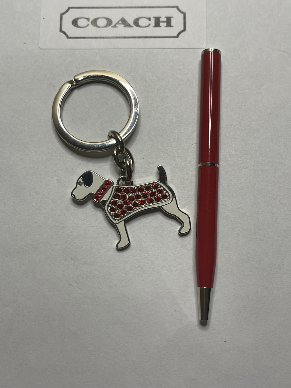 COACH Silver-Tone Dog Keychain Charm with Red Crystal Accents and Coach Pen